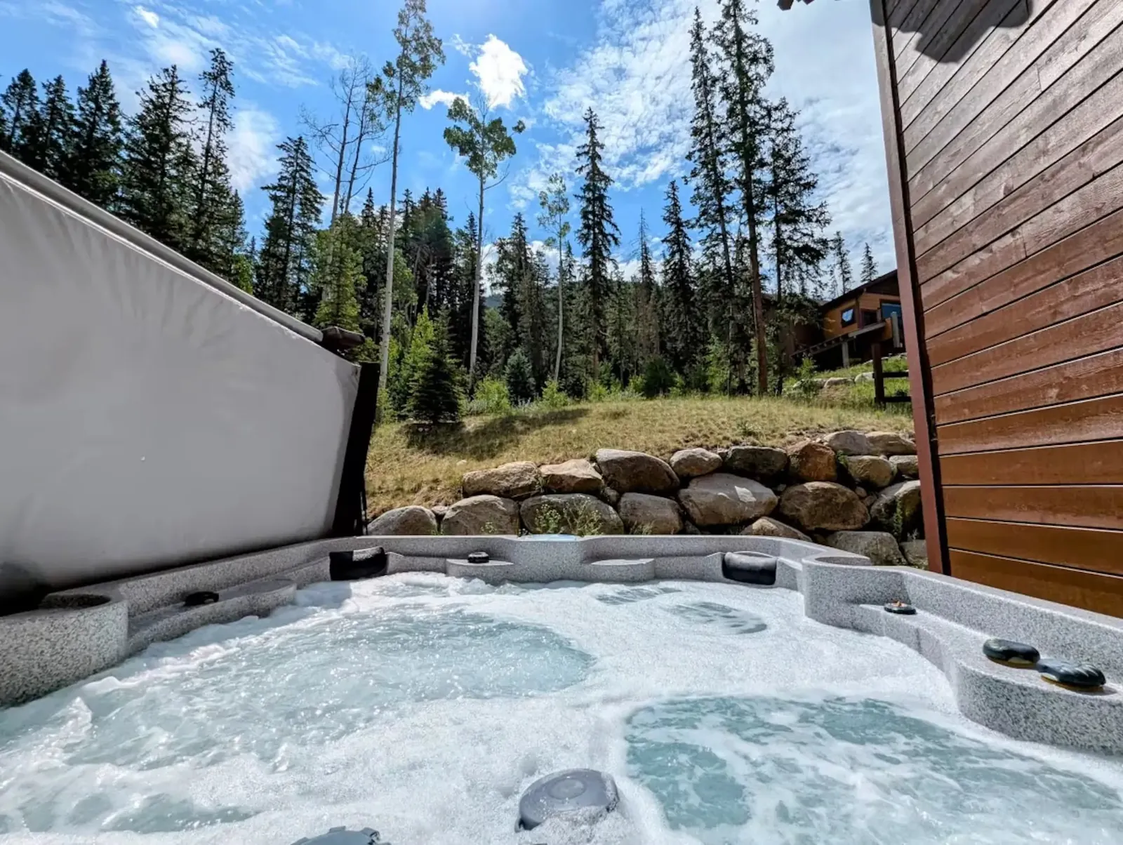 The Alders, Steaming hot tub against the mountain forest, luxury vacation rental in Keystone, Colorado