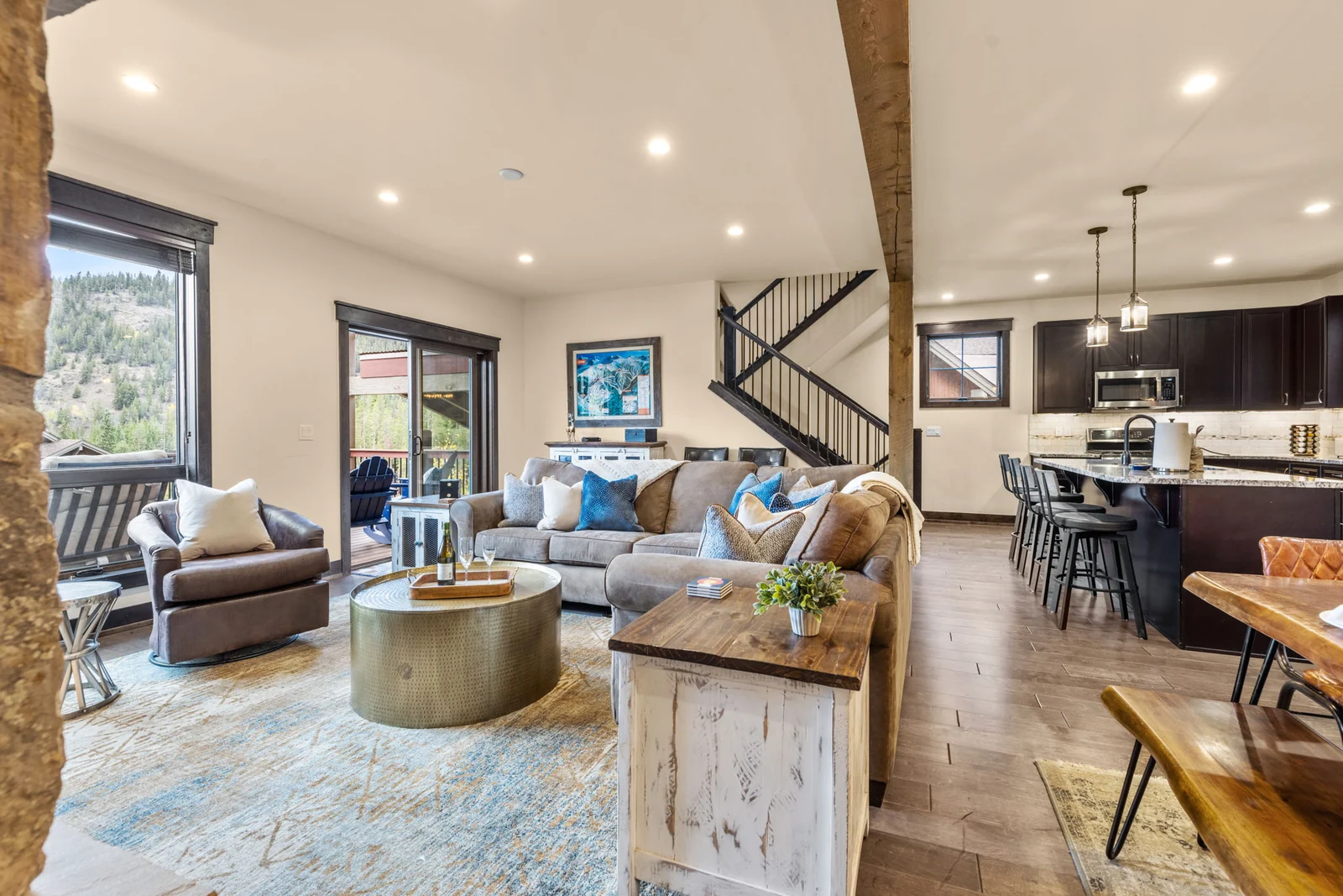 The Alders, Open living room with sofas and adjacent kitchen, luxury vacation rental in Keystone, Colorado