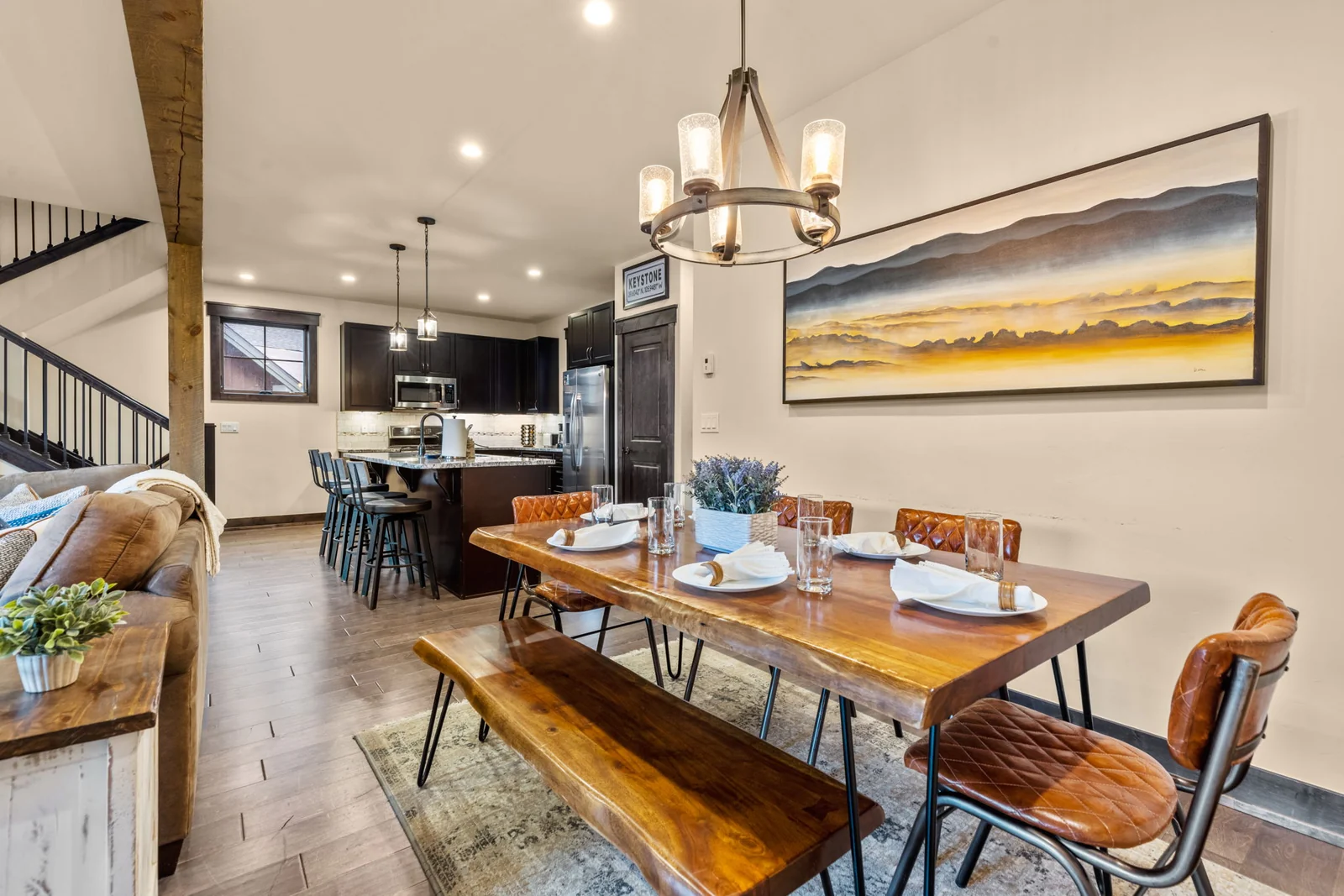 The Alders, Dining table opening to the kitchen and living room, luxury vacation rental in Keystone, Colorado