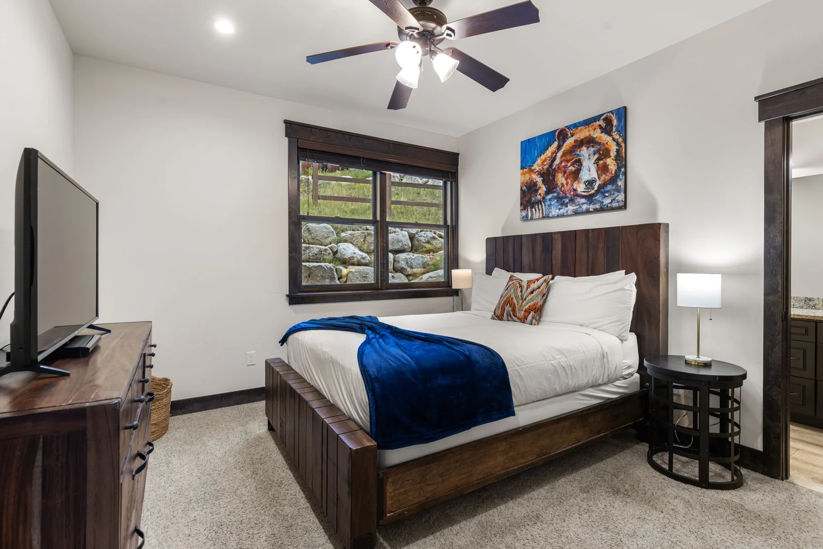 The Alders, Guest bedroom with wood bed frame and blue bedding, luxury vacation rental in Keystone, Colorado
