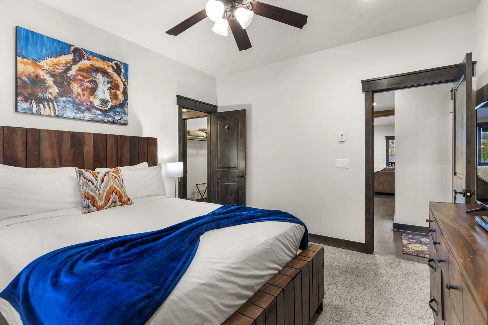 The Alders, Guest bedroom with wood headboard and mountain artwork, luxury vacation rental in Keystone, Colorado