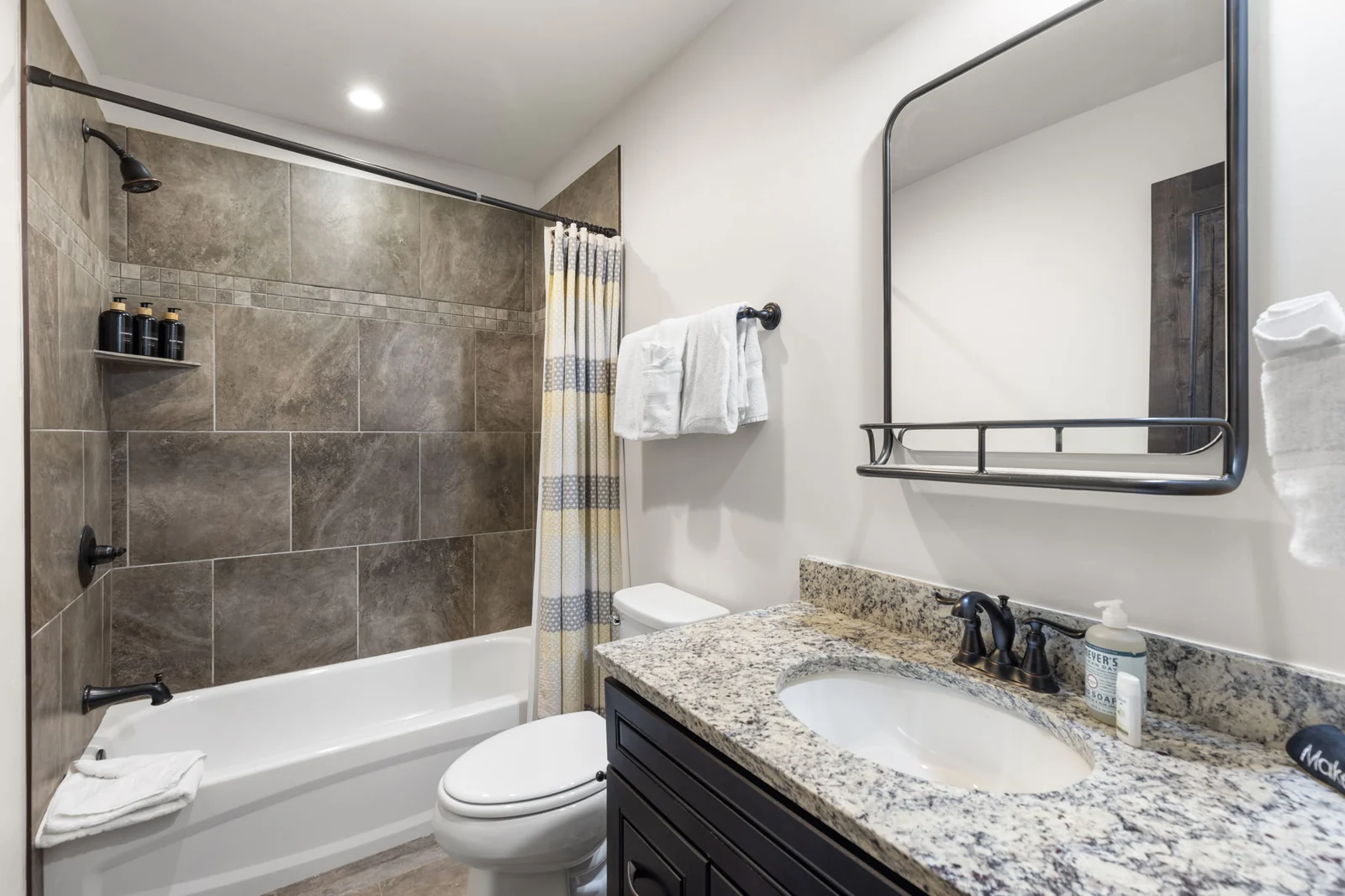 The Alders, Bathroom with bathtub and stone tile surround, luxury vacation rental in Keystone, Colorado