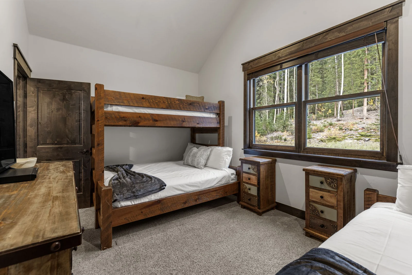 The Alders, Wooden bunk beds beside a picture window, luxury vacation rental in Keystone, Colorado