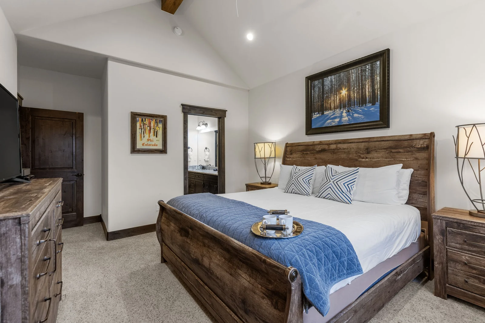 The Alders, Bright bedroom with blue throw and wood bed, luxury vacation rental in Keystone, Colorado